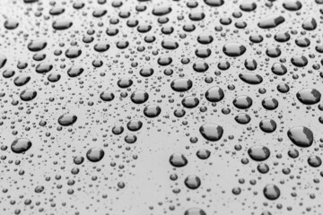 Pattern of water drops in a shining metallic surface with sky reflections,Water droplet on the car hood. Realistic pure water droplet water drops for creative banner design