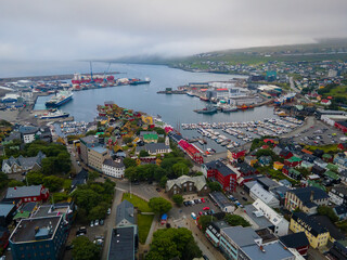 Obraz premium Beautiful aerial view of the City of Torshavn Capital of Faroe Islands- View of Cathedral, colorful buildings, marina, suburbs and Flag