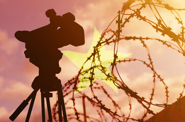 Double exposure - camera, barbed wire and flag Vietnam