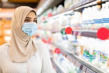 Portrait Of Muslim Woman In Supermarket, Wearing Hijab And Mask