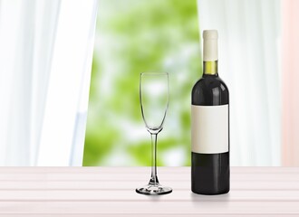 Tasting of burgundy red wine, glass and bottle of red wine