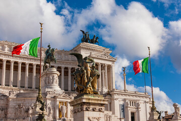 Obraz premium Altar of Nation or 'Vittoriano' monument, with Italian flags waving in the wind and beautiful clouds