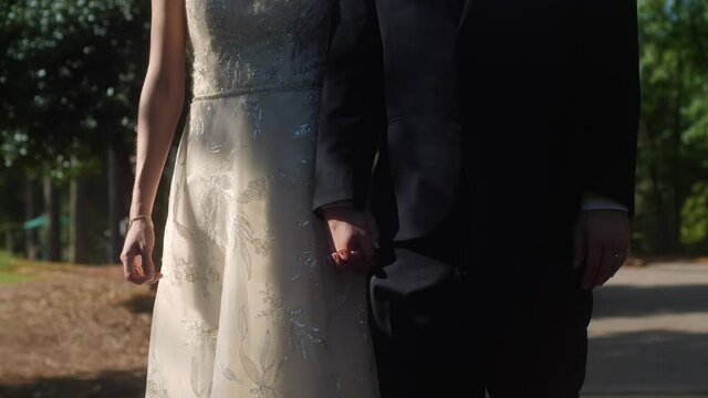 Bride and groom holding hands slow motion