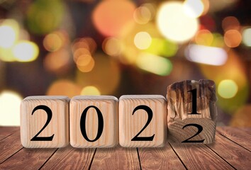 Flipping wooden cubes blocks on background for change year 2021 to 2022.