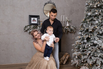 loving family with child enjoying their time together at home near decorated Christmas tree