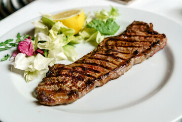 steak with salad in italian restaurant