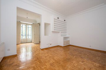 Vintage living room and bay window with white painted plaster shelving in a vacation rental apartment