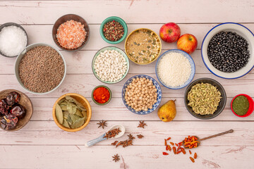 Set of different and beautiful bowls filled with raw products. Bell pepper seed, black beans, brown...