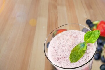 Tasty milkshake with blueberries in a glass on  background. Healthy dessert