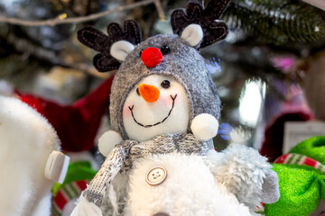 Bright colorful toy snowman on the shelf in the shop. Christmas and New Year celebration concept.