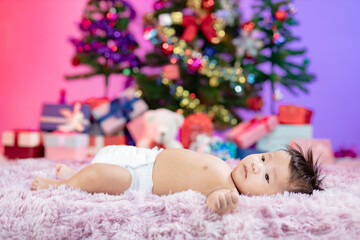 Obraz na płótnie Canvas Happy new year Christmas tree with cute little baby.