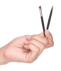 Hand holding Eyeliner brush isolated on white background.