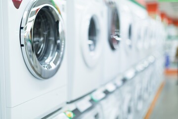 Washing machines, refrigerators and other home related appliance or equipment in the retail store - obrazy, fototapety, plakaty