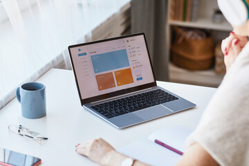 Close up of unrecognizable woman using laptop with e-education website at home, copy space