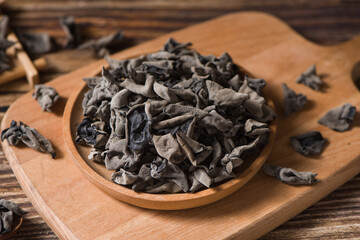 Dry black fungus or wood ear mushroom on wood background