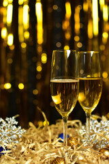 Glasses of champagne on golden background. new year and christmas celebration