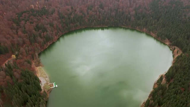Bird's eye ascending shot above Lake Sfanta Ana in crater of Ciomadul volcano