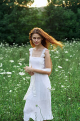 Fototapeta na wymiar Woman in white dress flowers nature walk charm