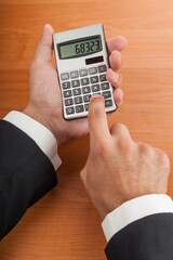 Close-up of a Businessman with Calculator
