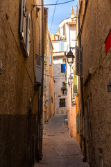View of narrow streets in small French town of Hyeres in sunny summer day, Var department..