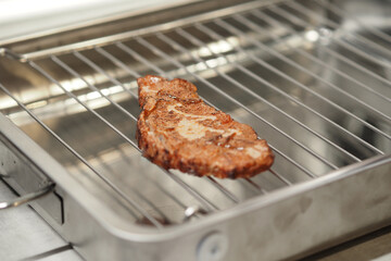 Meat steak cooked on an electric grill.