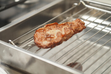 Meat steak cooked on an electric grill.