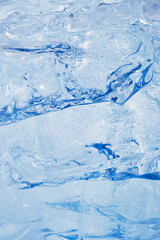 Texture of winter ice surface. Blue natural ice background