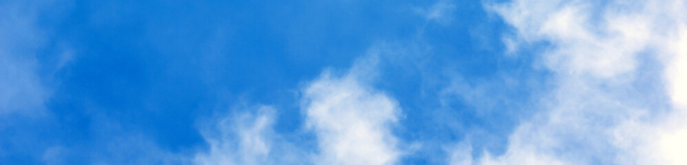Blue sky background with white clouds. Panorama