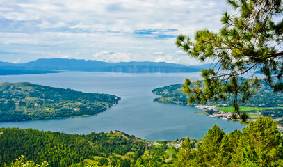 Fototapeta premium The beauty of Lake Toba which is a caldera lake comes from an ancient volcanic eruption and is the largest volcanic lake in the world. View from geosite hutaginjang. North Sumatra, Indonesia