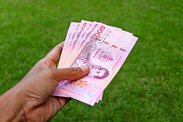Several hundred baht banknotes in hand. Concept of finance real.