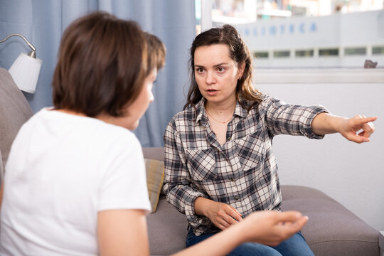 Two unhappy woman having conflict at home. High quality photo