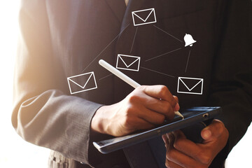 Closeup businessmen hand using tablet with email icon