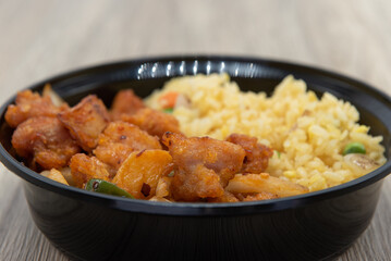 Tradiional Chinese fast food meal with fried rice and seasoned chicken in a perfect size bowl.