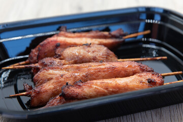 Side order of teriyaki chicken skewers as a perfect appetizer before a Chinese food meal.