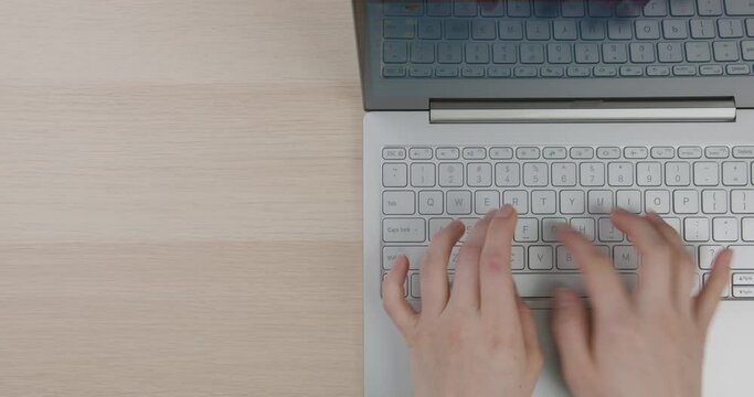 Office desk top view. Bright workplace with girl's hands, laptop. Flat lay. Copy space. Close-up.