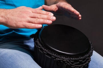 Man Playing the African Djembe Drum