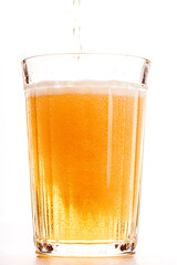 Beer in a faceted glass on a white background