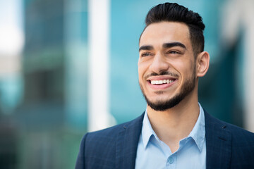 Fototapeta premium Closeup portrait of happy middle eastern young businessman, copy space