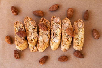 Sweet Italian cookies - cantucci (cantuccini) or biscotti with almond on craft paper, top view....
