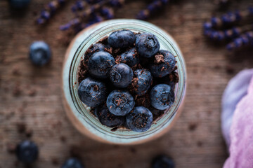 Healthy chia pudding with blueberries in jar on the rustic background. Selective focus. Shallow depth of field.