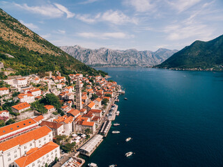 Fototapeta na wymiar Red tiled roofs of houses in Perast on the shore of the Kotor Bay. Montenegro