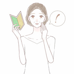 初心者マークを持って驚いている中年女性