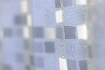 Water drops on transparent shower curtain in detail frame without people