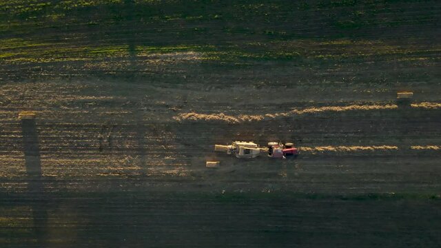 Top-Down Aerial Of Tractor Dropping Bale Of Corn Stalks In Field Pennsylvania, U.S.A., Farmland