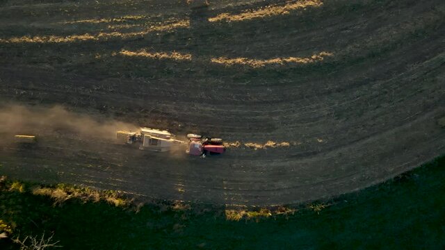 Top-Down Aerial Following Tractor Baling Corn Stalks In In Rural Pennsylvania, U.S.A.