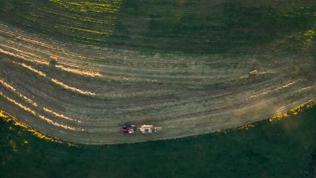 Top-Down Aerial Of Tractor Pulling Baling Machine In In Rural Pennsylvania, U.S.A.