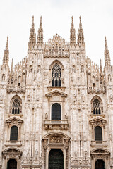Fototapeta na wymiar Facade of the Duomo Cathedral from the central entrance. Italy, Milan