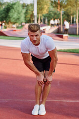 Obraz premium man in white t-shirt on the sports ground workout motivation