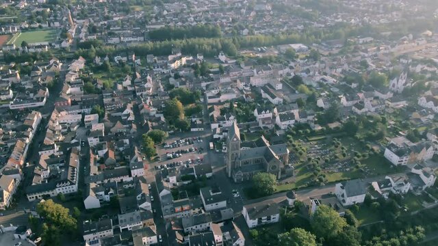 Aerial shot over a historic church in a picturesque German town in summer sun