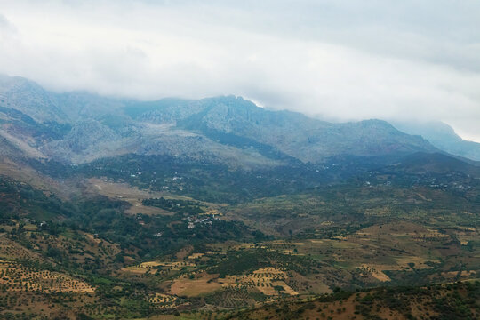 Moroccan landscape with foggy mountains and fields. © Renar